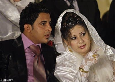 حفل زفاف جماعي في بغداد مكون من 15 شاب وفتاه تحت رعاية الحكومة العراقية.