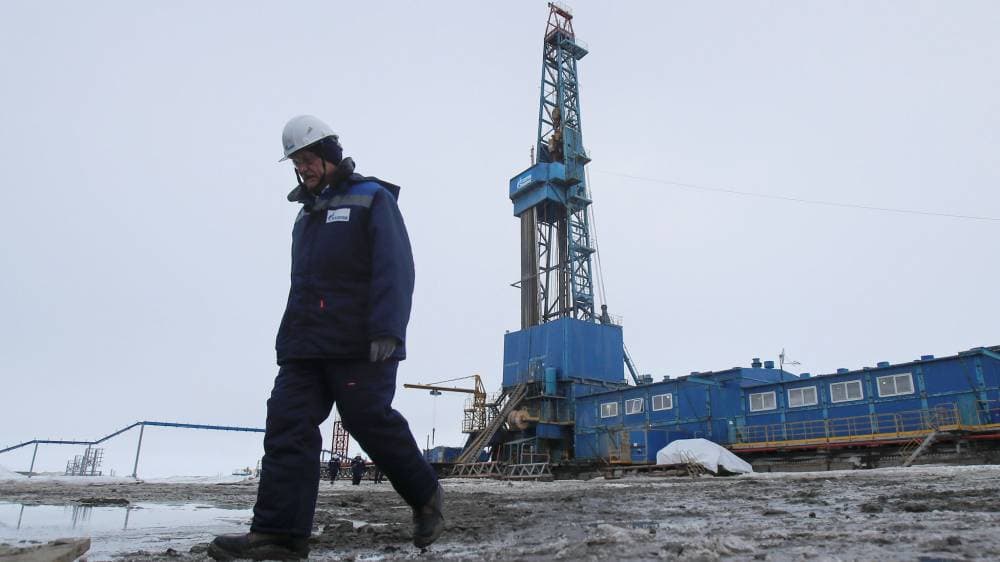 A man walks near a drilling rig at a gas processing facility, operated by Gazprom company, at Bovanenkovo gas field on the Arctic Yamal peninsula, Russia May 21, 2019. Picture taken May 21, 2019. REUTERS/Maxim Shemetov - RC1C47931250