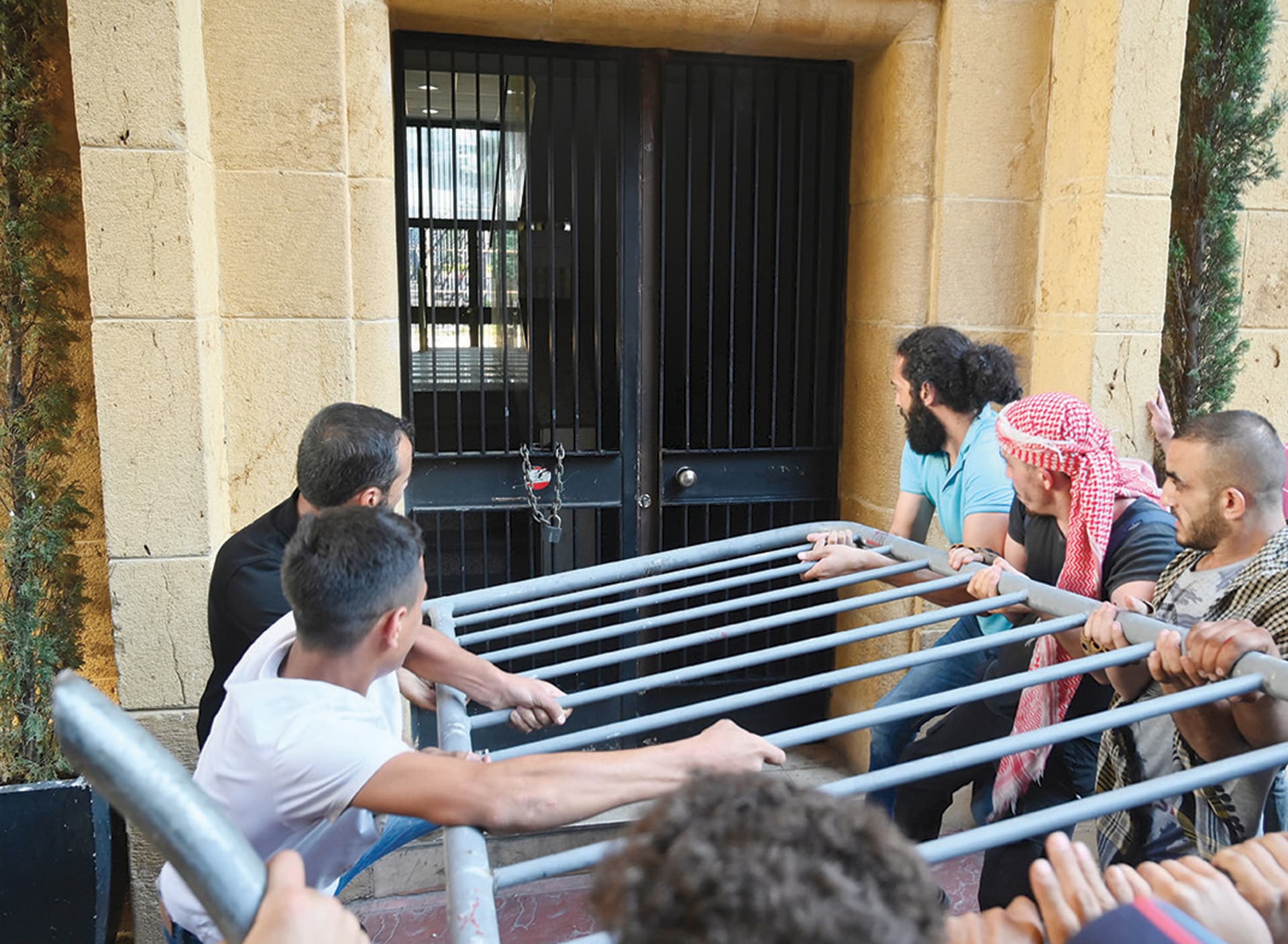 متظاهرون يحاولون اقتحام بوابة وزارة الاقتصاد اللبنانية خلال احتجاج على انقطاع التيار الكهربائي