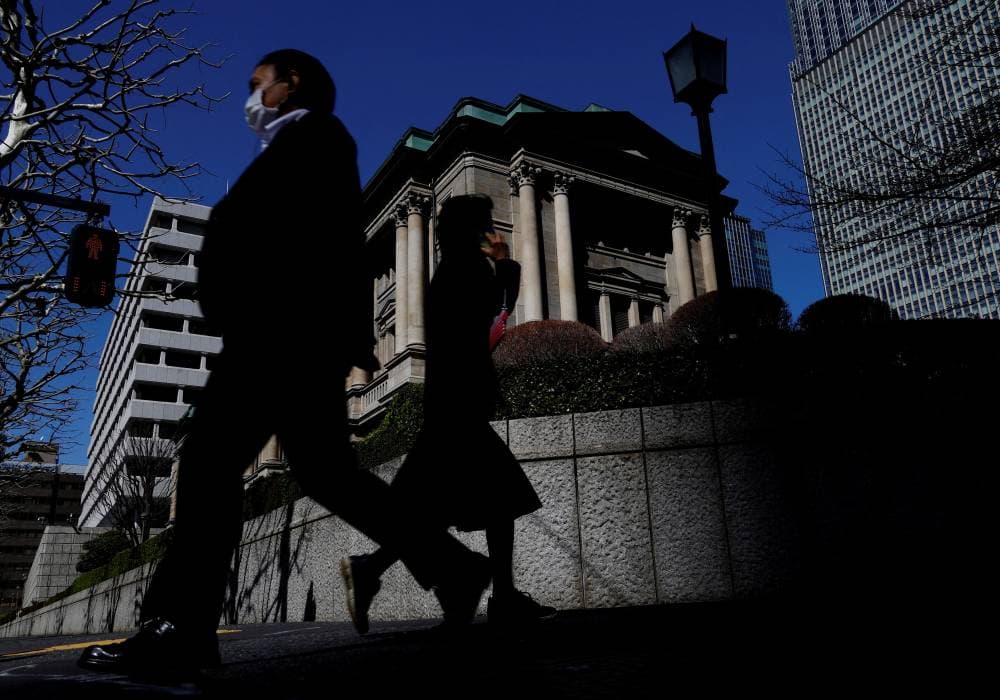 FILE PHOTO: Pedestrians walk past the Bank of Japan building in Tokyo, Japan March 18, 2024. REUTERS/Kim Kyung-Hoon/File Photo