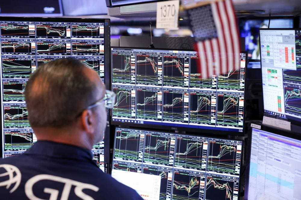 A trader works at the New York Stock Exchange (NYSE) next to a U.S. flag, after Republican Donald Trump won the U.S. presidential election, in New York City, U.S., November 6, 2024. REUTERS/Andrew Kelly