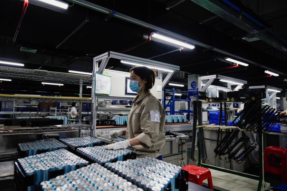 FILE PHOTO: An employee works on the production line of electric vehicle (EV) battery manufacturer Octillion in Hefei, Anhui province, China March 30, 2021. Picture taken March 30, 2021. REUTERS/Aly Song