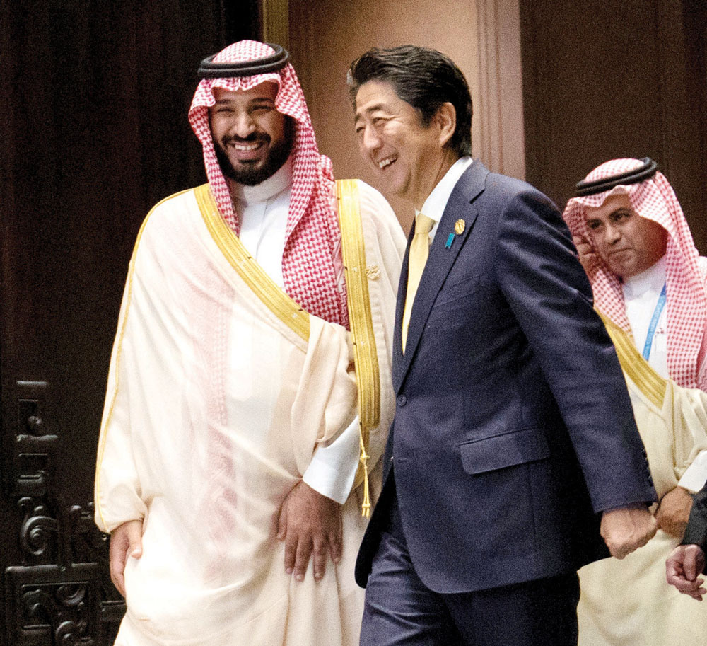 ولي ولي العهد يدخل إلى قاعة اجتماعات القمة برفقة رئيس الوزراء الياباني. «رويترز»