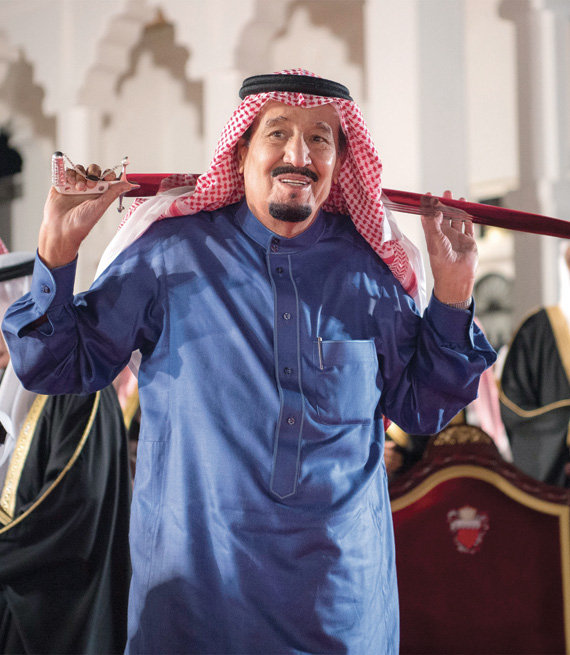 الملك سلمان خلال مشاركته في العرضة في حفل استقبال أعدته له البحرين في المنامة أمس.تصوير: بندر الجلعود - «الاقتصادية»