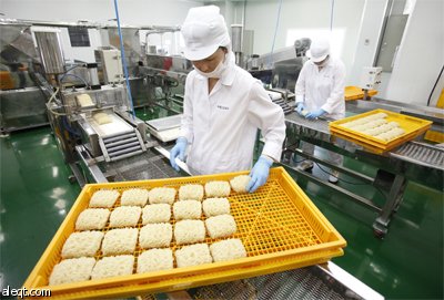 عامل كوري جنوبي يرتب المعجنات الفورية في مصنع للمعكرونة في كانغهوا.