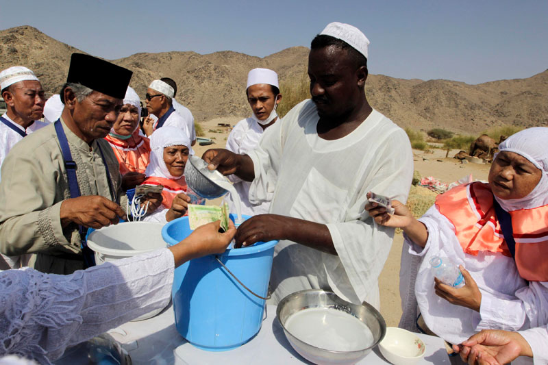 حجاج اندونيسيون يلتقطون صور تذكارية في مزرعة للإبل في مكة المكرمة