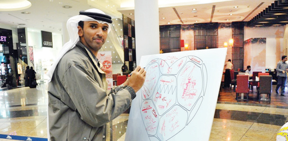 الشيخ علي بن خليفة آل خليفة أثناء توقيعه على المشاركة في الحملة الشبابية (البحرين قلب واحد)