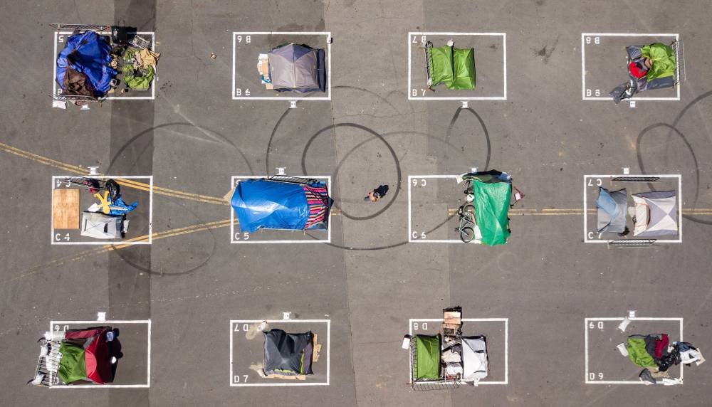 مربعات مرسومة على الأرض لوضع مسافة بين المتشردين في مدينة سان فرانسيسكو الأمريكية لضمان التباعد الاجتماعي في ظل أزمة كورونا. «الفرنسية »