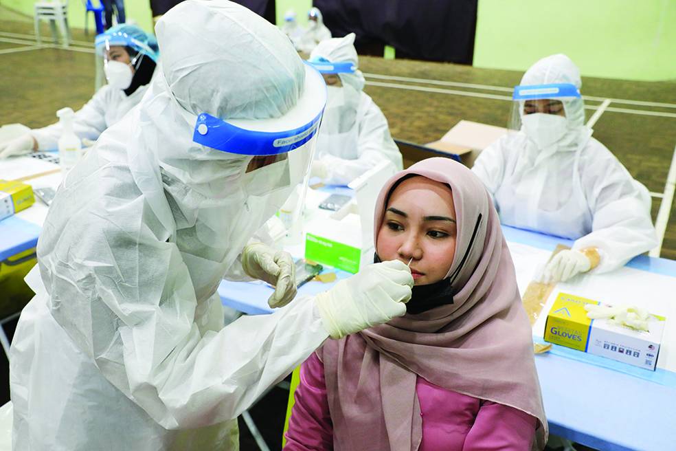 فتاة ماليزية تخضع لفحص كورونا في العاصمة كوالالمبور. «رويترز»