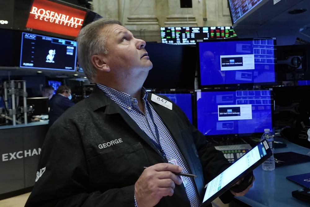 Trader George Ettinger works on the floor of the New York Stock Exchange, Monday, Nov. 1, 2021. Stocks are opening modestly higher on Wall Street Monday, bringing major indexes a bit further past the record highs they set last week. (AP Photo/Richard Drew)