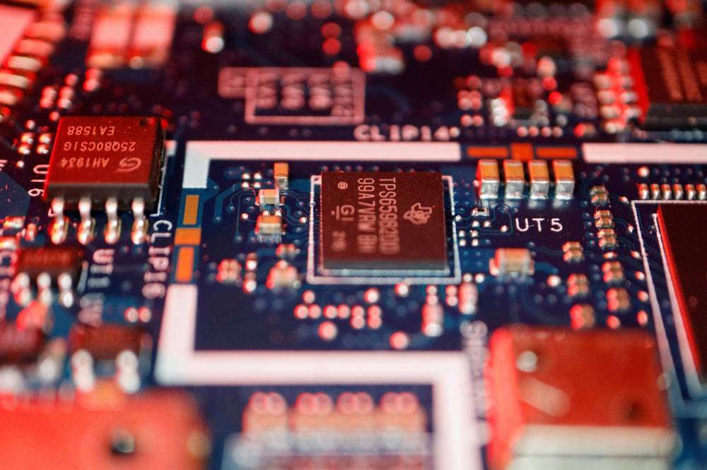 FILE PHOTO: Semiconductor chips are seen on a circuit board of a computer in this illustration picture taken February 25, 2022. REUTERS/Florence Lo/Illustration
