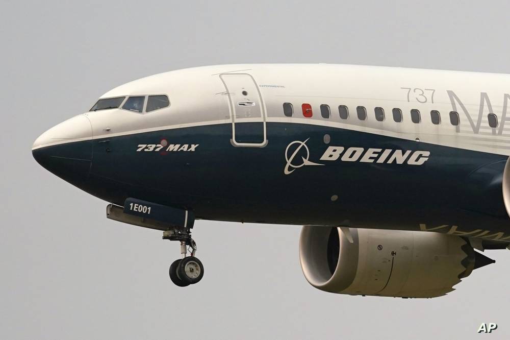 FILE - A Boeing 737 Max jet prepares to land at Boeing Field following a test flight in Seattle, Sept. 30, 2020.  Air India is placing orders for 470 Boeing and Airbus aircraft, underlining the surging demand for air travel fueled by the country’s swelling middle class.(AP Photo/Elaine Thompson, File)
