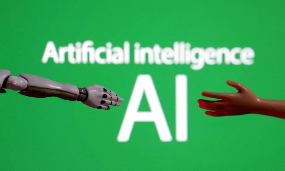 FILE PHOTO: Words reading "Artificial intelligence AI", miniature of robot and toy hand are pictured in this illustration taken December 14, 2023. REUTERS/Dado Ruvic/Illustration/File Photo