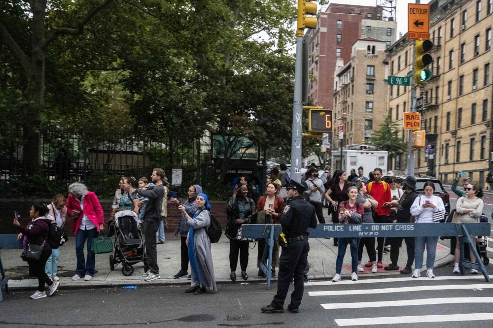 Residents wait for 96th street to open back up as the motorcade with US President Joe Biden passes by in the Upper East Side in New York, New York, on September 25, 2024. During the UN General Assembly (UNGA) the streets of New York turn into a maze of barricades and closed streets as world leaders descend on the city and street closures from motorcades cause an inconvenience for residents and an spectacle for tourists at the same time. (Photo by ANDREW CABALLERO-REYNOLDS / AFP)