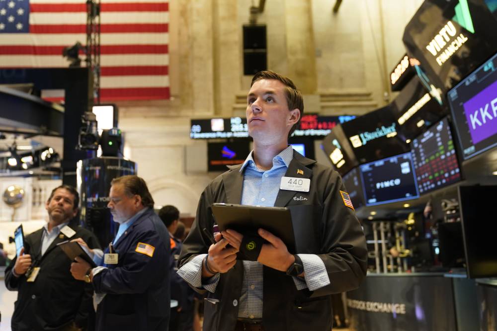 Traders work on the floor at the New York Stock Exchange in New York, Tuesday, June 14, 2022. Wall Street is wobbling between gains and losses Tuesday in its first trading after tumbling into a bear market on worries about a fragile economy and rising rates. (AP Photo/Seth Wenig)