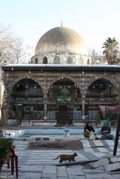 سياح غربيين يزورون مسجد في دمشق يرجع إلى الحقبة العثمانية.