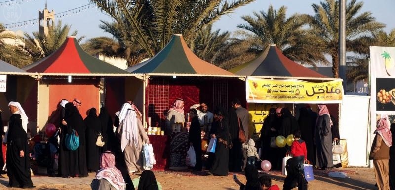 الزوار يأكلون ثمراً جنيّا في مهرجان النخيل والتمور